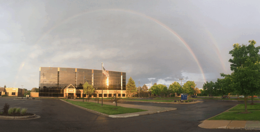 SSC building with rainbow in the sky behind it